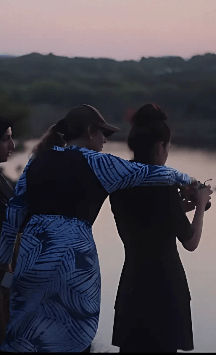 Two people dancing by the water